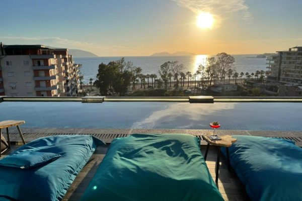 Ames Hotel Spa in Vlorë poolside view with sunset