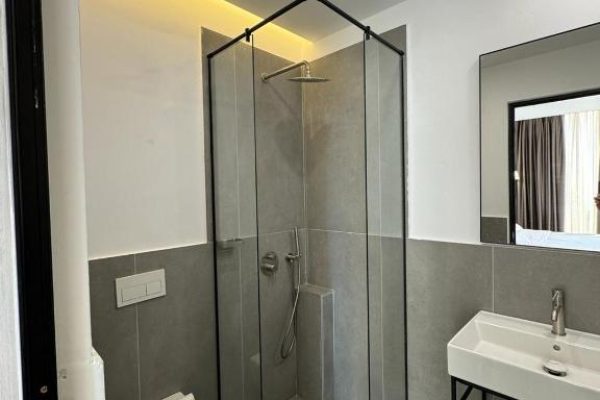 green condo hotel palase bathroom with a shower and toilet and sink