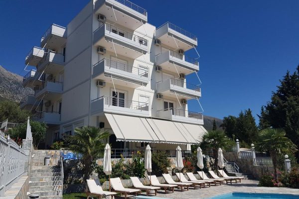 perivolos apartments in albania, outside the building with a clear view of the apartements and the pool.