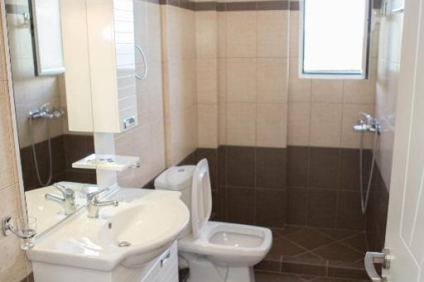 perivolos apartments in albania on the toilet where you have a sink and a shower to freshen up