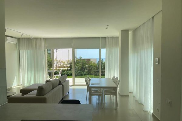 villa 60b the livingroom shot from the kitchen with a view that goes over the ocean